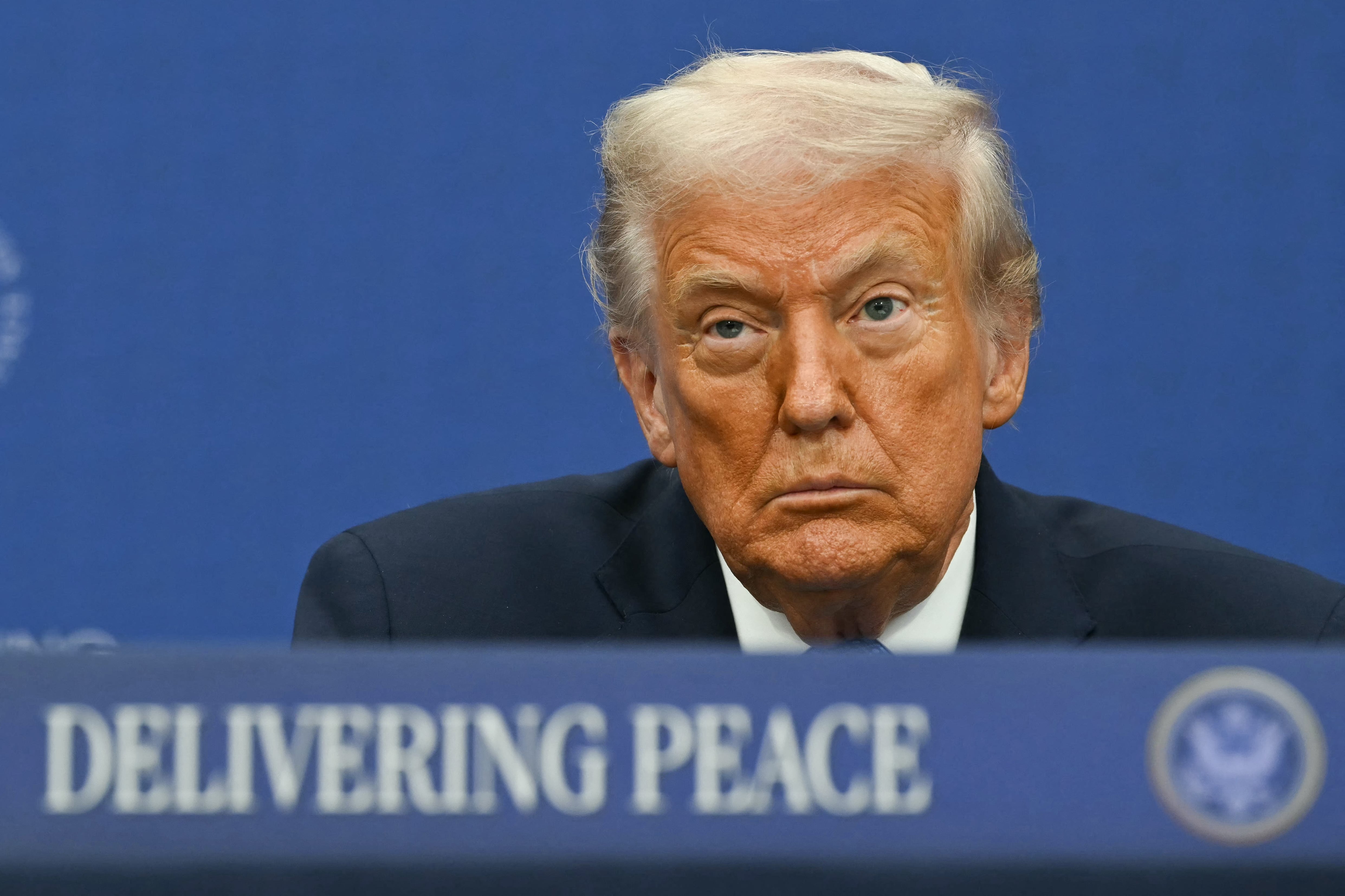 US President Donald Trump attends the signing ceremony of a peace deal with the President of Rwanda Paul Kagame and the President of the Democratic Republic of the Congo Felix Tshisekedi at the United States Institute of Peace in Washington, DC, on December 4, 2025. Trump on Thursday brings the leaders of Rwanda and the Democratic Republic of Congo together to endorse a deal that Trump has hailed as his latest peace triumph despite ongoing violence on the ground. Trump hopes the agreement will pave the way for the United States to gain access to critical minerals in the eastern DRC, a violence-torn region home to many of the key ingredients in modern technologies such as electric cars. (Photo by ANDREW CABALLERO-REYNOLDS / AFP)