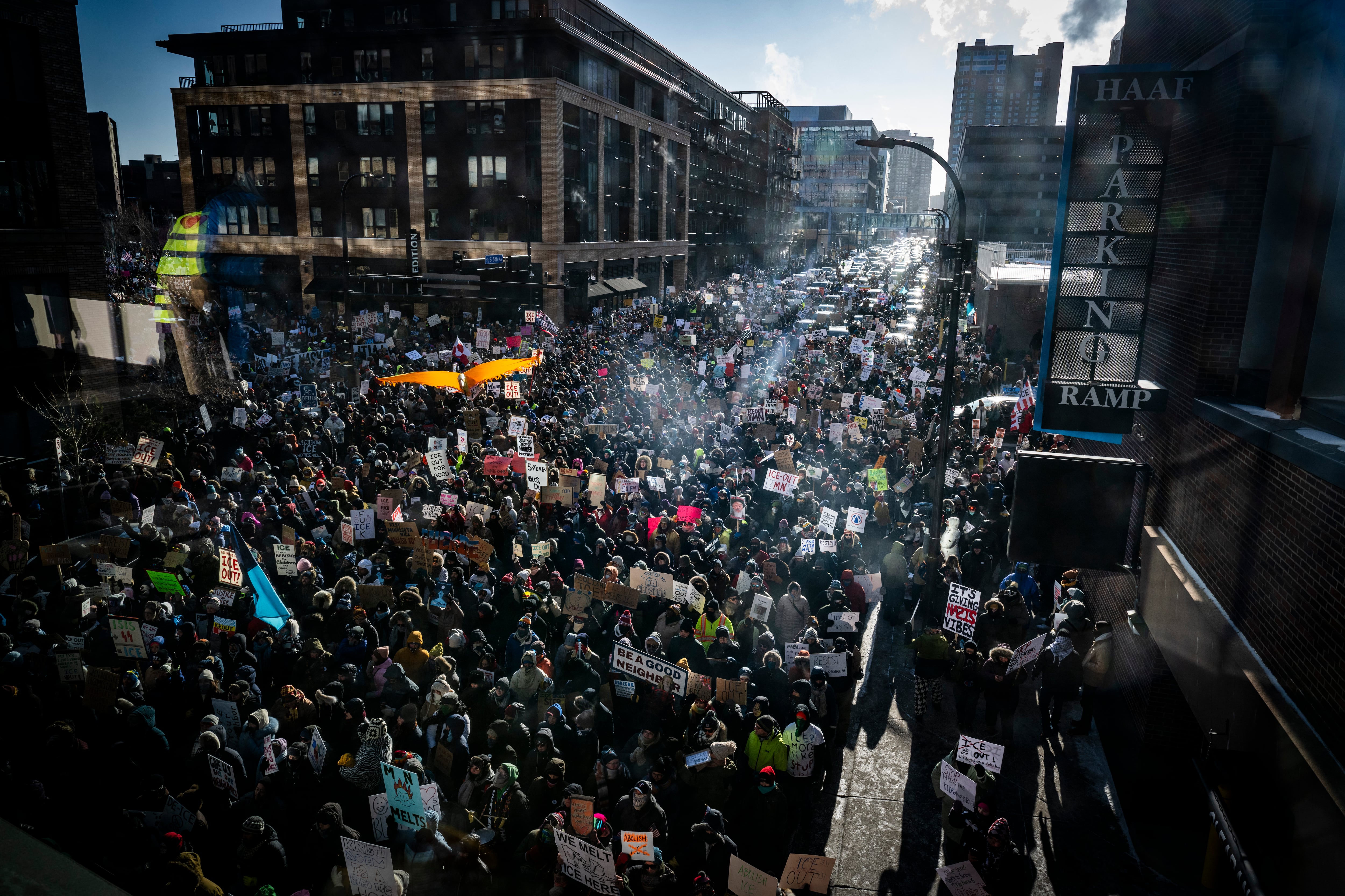 A large crowd marches down a street during during the "ICE out of Minnesota: Day of Truth and Freedom" protest in Minneapolis, Minnesota on January 23, 2026. The Pentagon has ordered 1,500 US soldiers to prepare for a possible deployment to a state roiled by unrest over an immigration crackdown, US media reported on January 18. The reported preparations come days after President Donald Trump threatened to invoke the Insurrection Act, which enables use of the military to suppress "armed rebellion" or "domestic violence" -- although a day later he said there was no immediate need for it. (Photo by ROBERTO SCHMIDT / AFP)