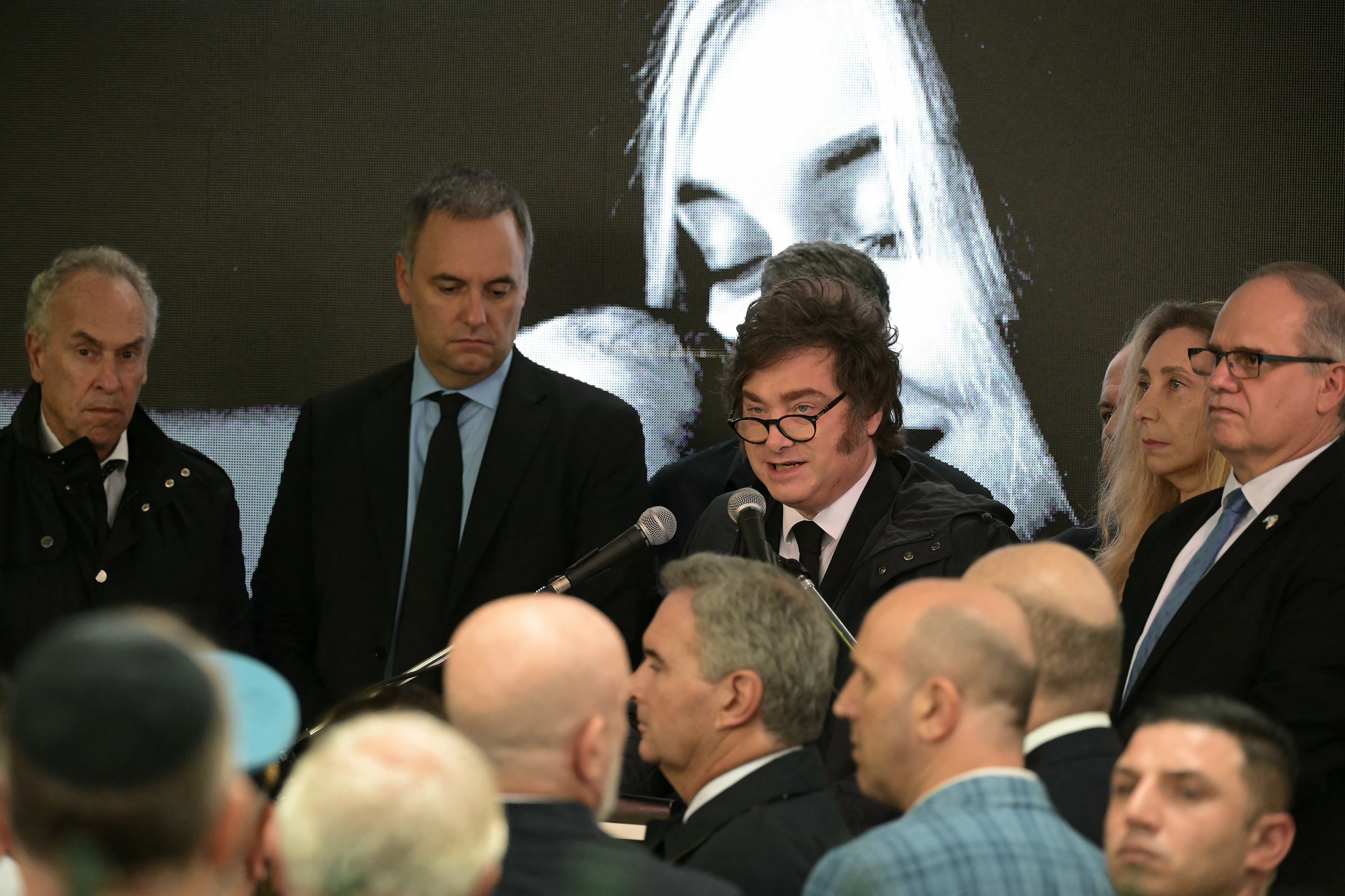 Argentina’s President Javier Milei (C) speaks next to his Chief of Cabinet Manuel Adorni (2-L), Presidency Secretary Karina Milei and Israel ambassador to Argentina Eyal Sela (R)