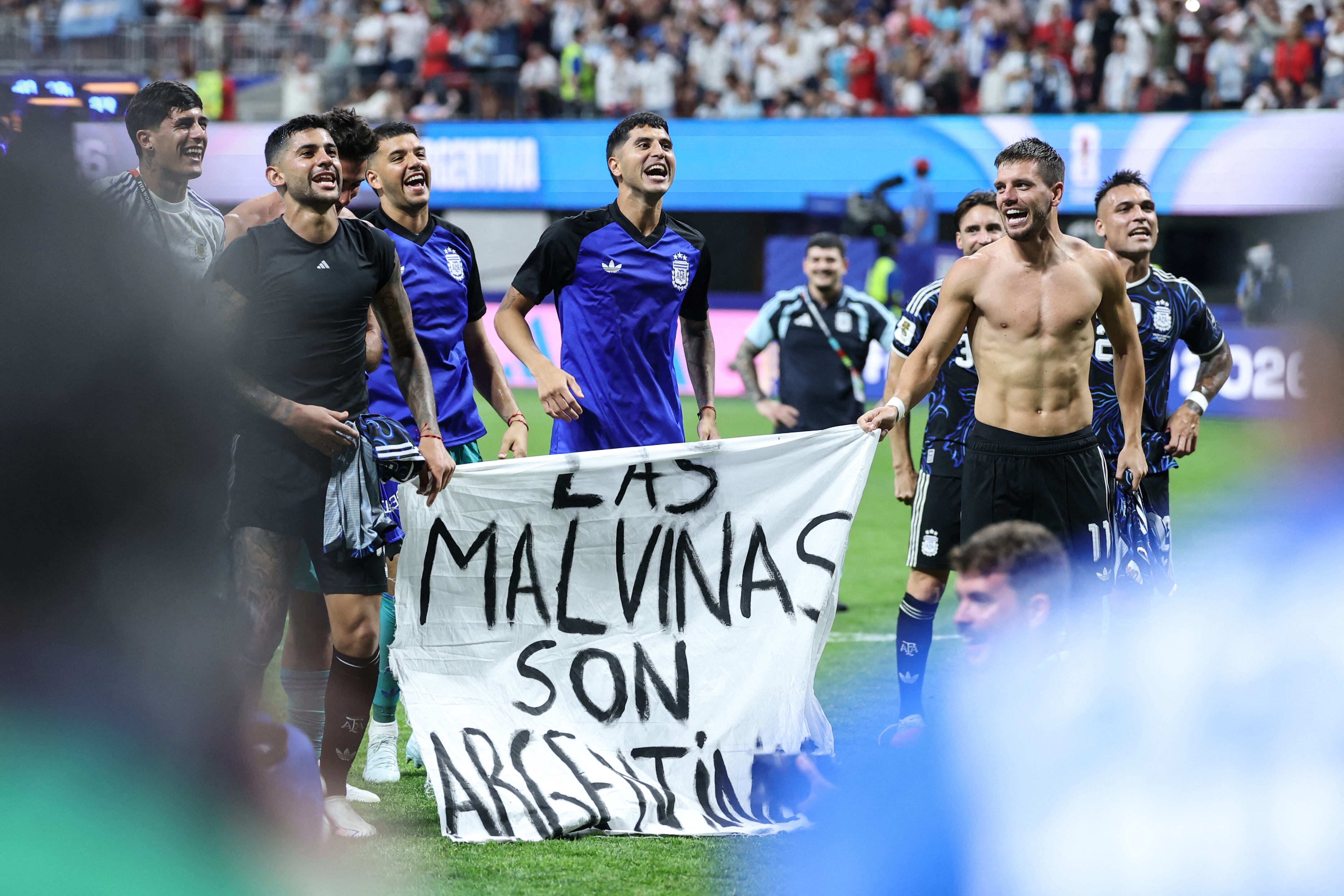 Argentina's players show a banner that reads in Spanish, "The Malvinas (Falkland Islands) belong to Argentina," after winning the 2026 World Cup football