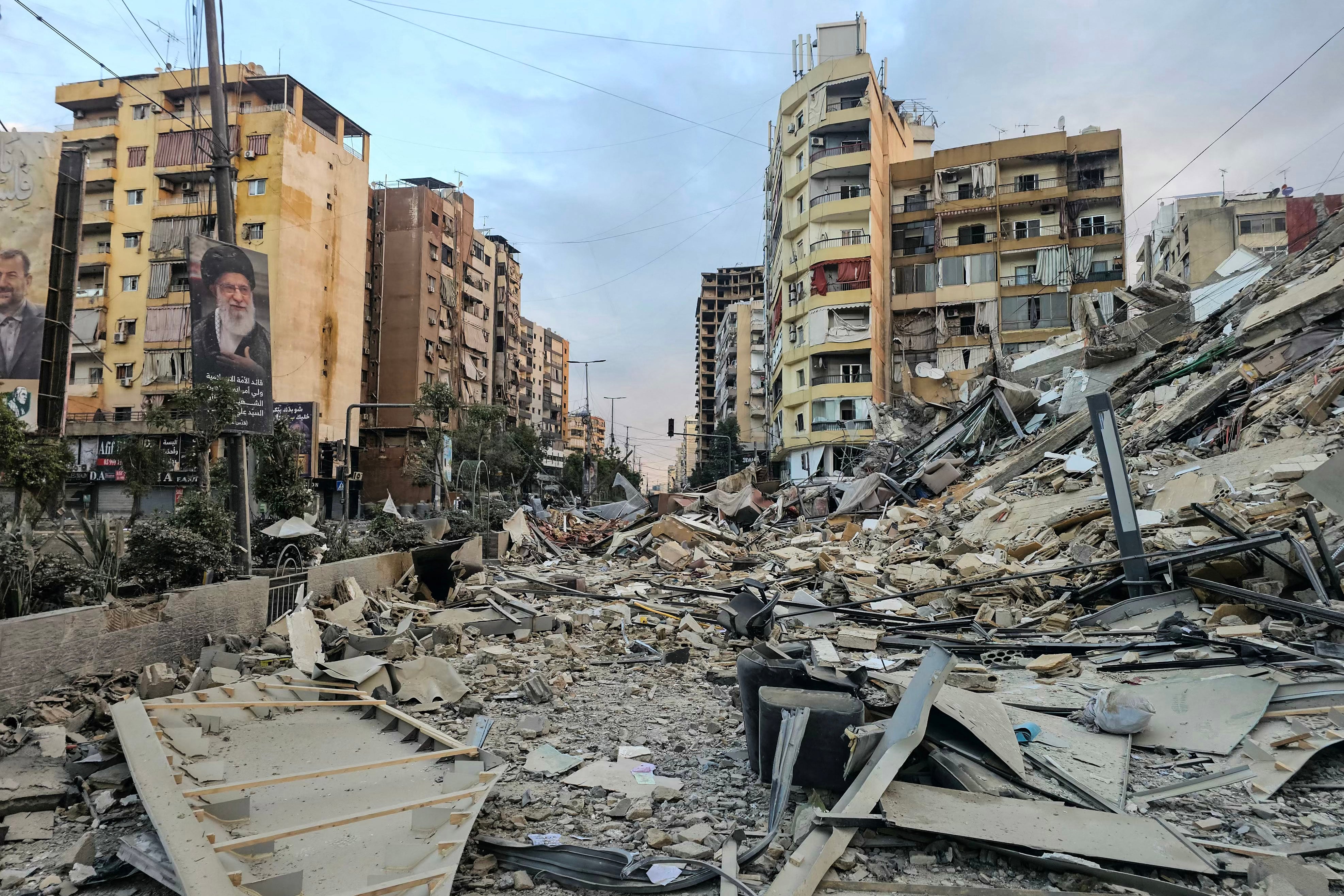 A photograph shows a portrait of Iran’s slain supreme leader Ayatollah Ali Khamenei and the rubble of a destroyed building at the site of an overnight Israeli airstrike in Beirut’s southern suburbs on March 28, 2026. Israel's military renewed its attacks on Beirut's southern suburbs on March 27, saying it was targeting Hezbollah infrastructure, as the Iran-backed group said the foes had clashed directly in the country's south. (Photo by AFP) /