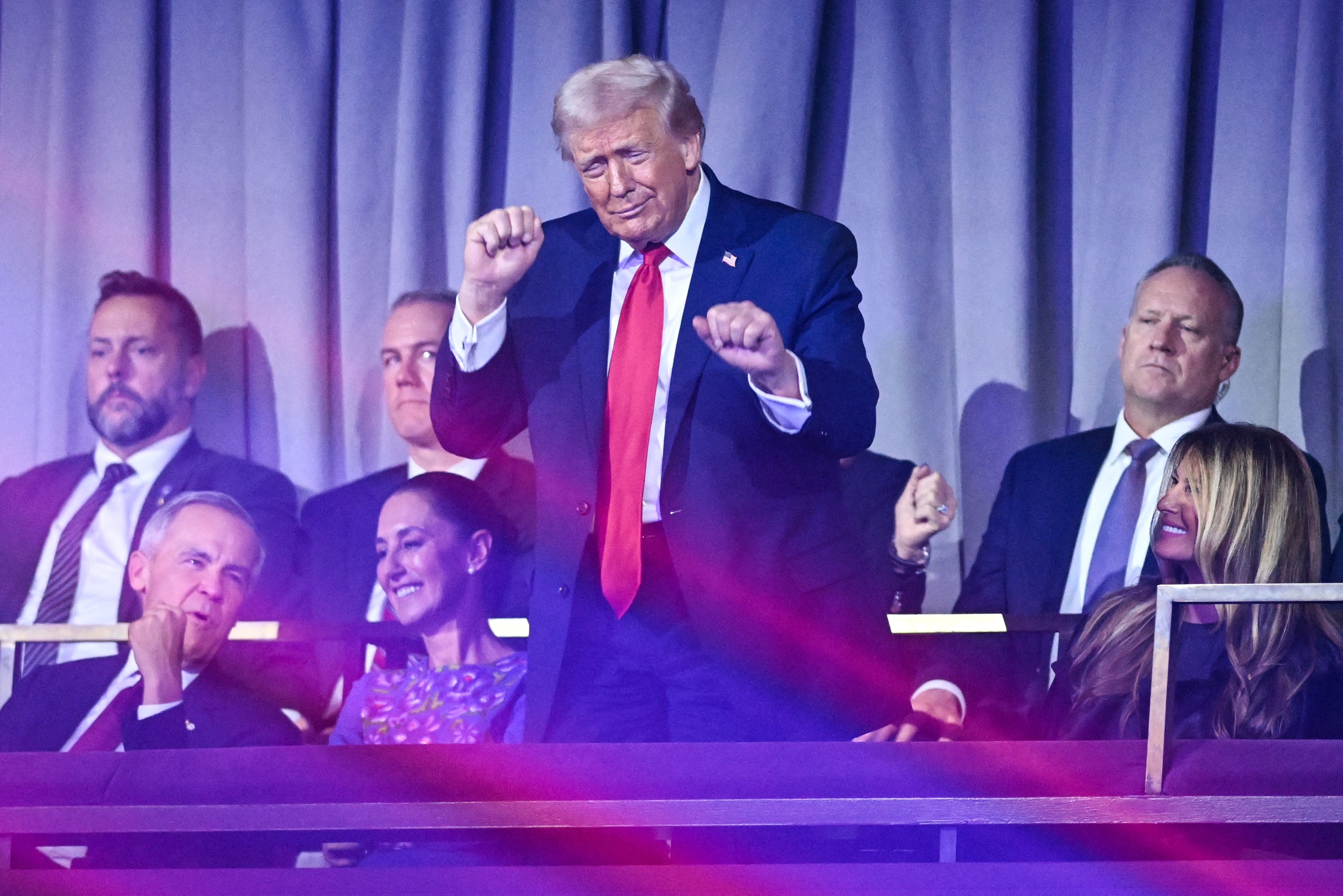 US President Donald Trump dances after the results of the draw for the 2026 FIFA Football World Cup taking place in the US, Canada and Mexico, at the Kennedy Center, in Washington, DC, on December 5, 2025. (Photo by SAUL LOEB / AFP)