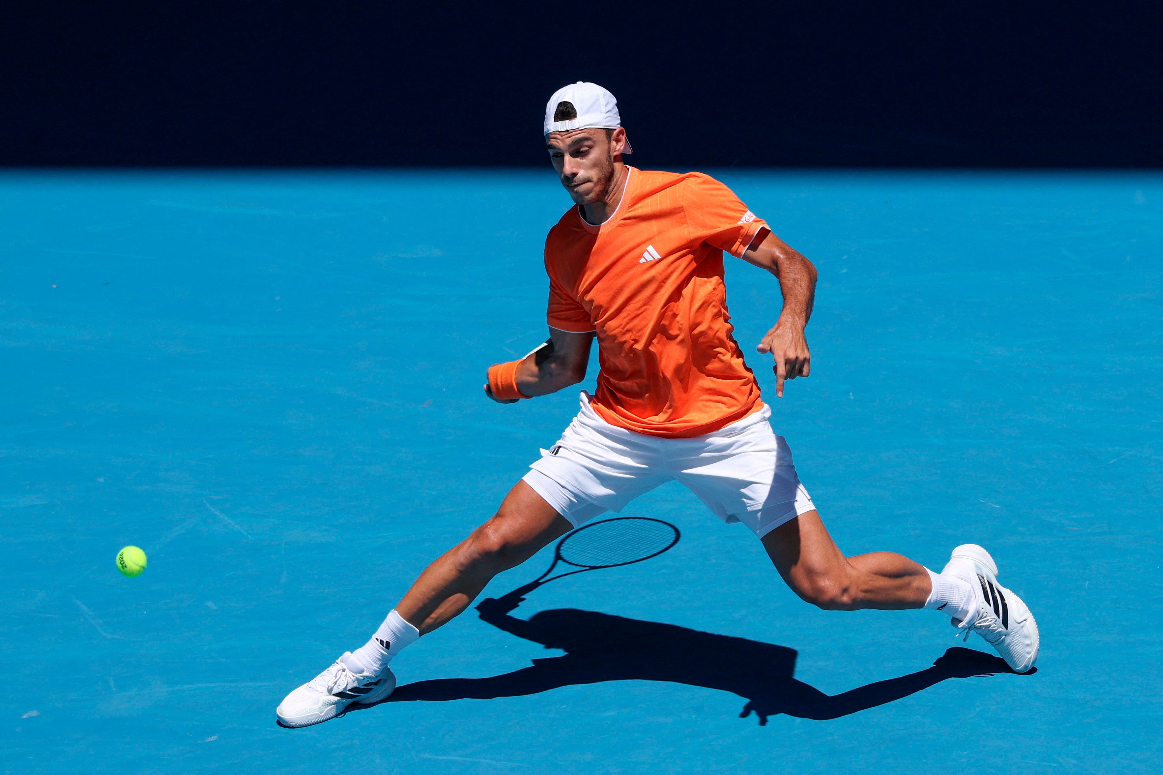 Argentina’s Francisco Cerundolo hits a return to China's Zhang Zhizhen during their men's singles match on day one of the Australian Open tennis tournament in Melbourne on January 18, 2026. (Photo by DAVID GRAY / AFP) / -- IMAGE RESTRICTED TO EDITORIAL USE - STRICTLY NO COMMERCIAL USE --
