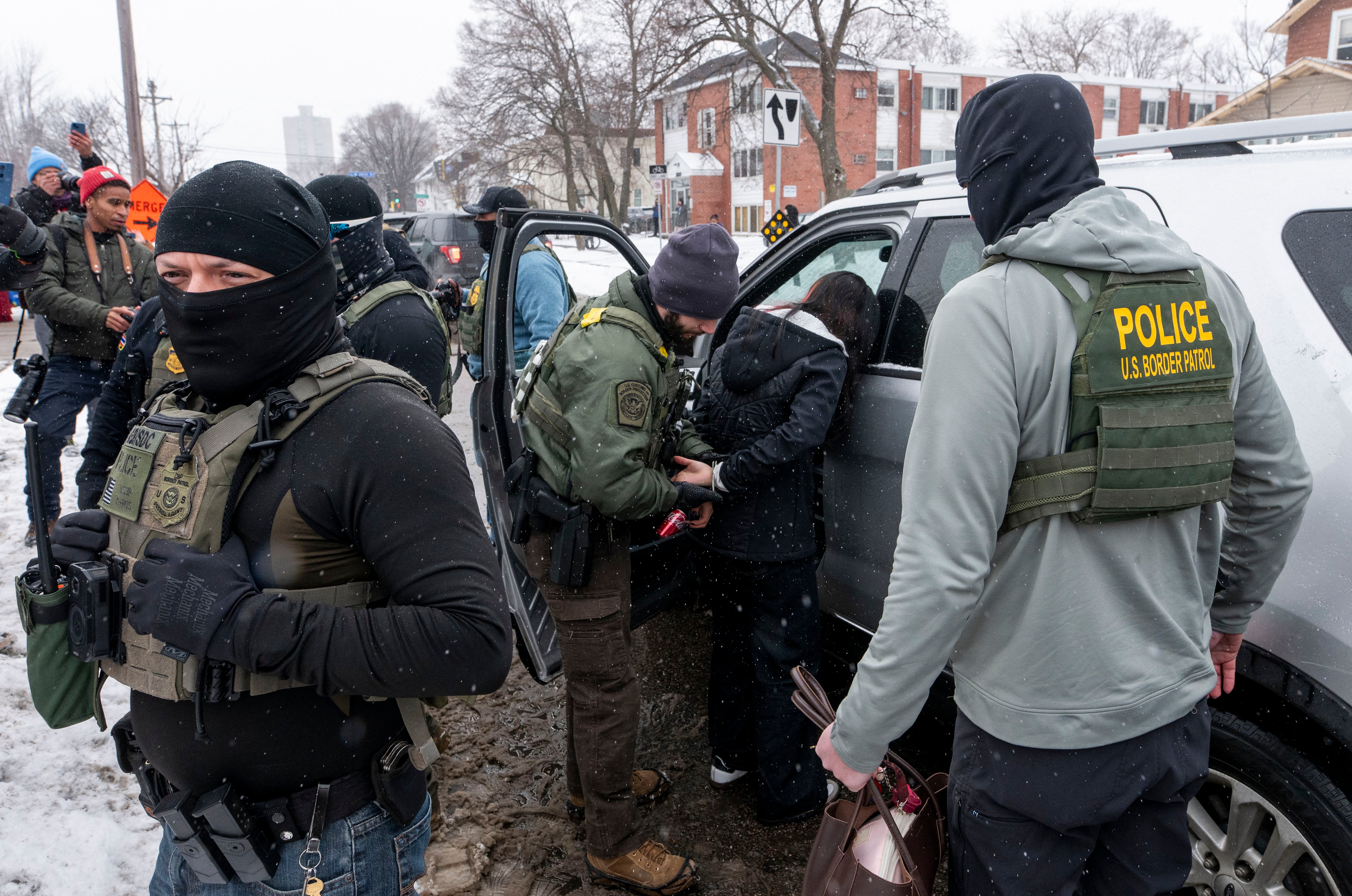 MINNEAPOLIS, MINNESOTA - JANUARY 21: A teenage girl is arrested on Blaisdell Avenue after colliding with a Border Patrol vehicle on January 21, 2026 in Minneapolis, Minnesota. A teenage boy and girl, and multiple observers, were arrested by Border Patrol after the incident. The Trump administration has sent a reported 3,000 federal plus federal agents into the area, with more on the way, as they make a push to arrest undocumented immigrants in the region.   Stephen Maturen/Getty Images/AFP (Photo by Stephen Maturen / GETTY IMAGES NORTH AMERICA / Getty Images via AFP)