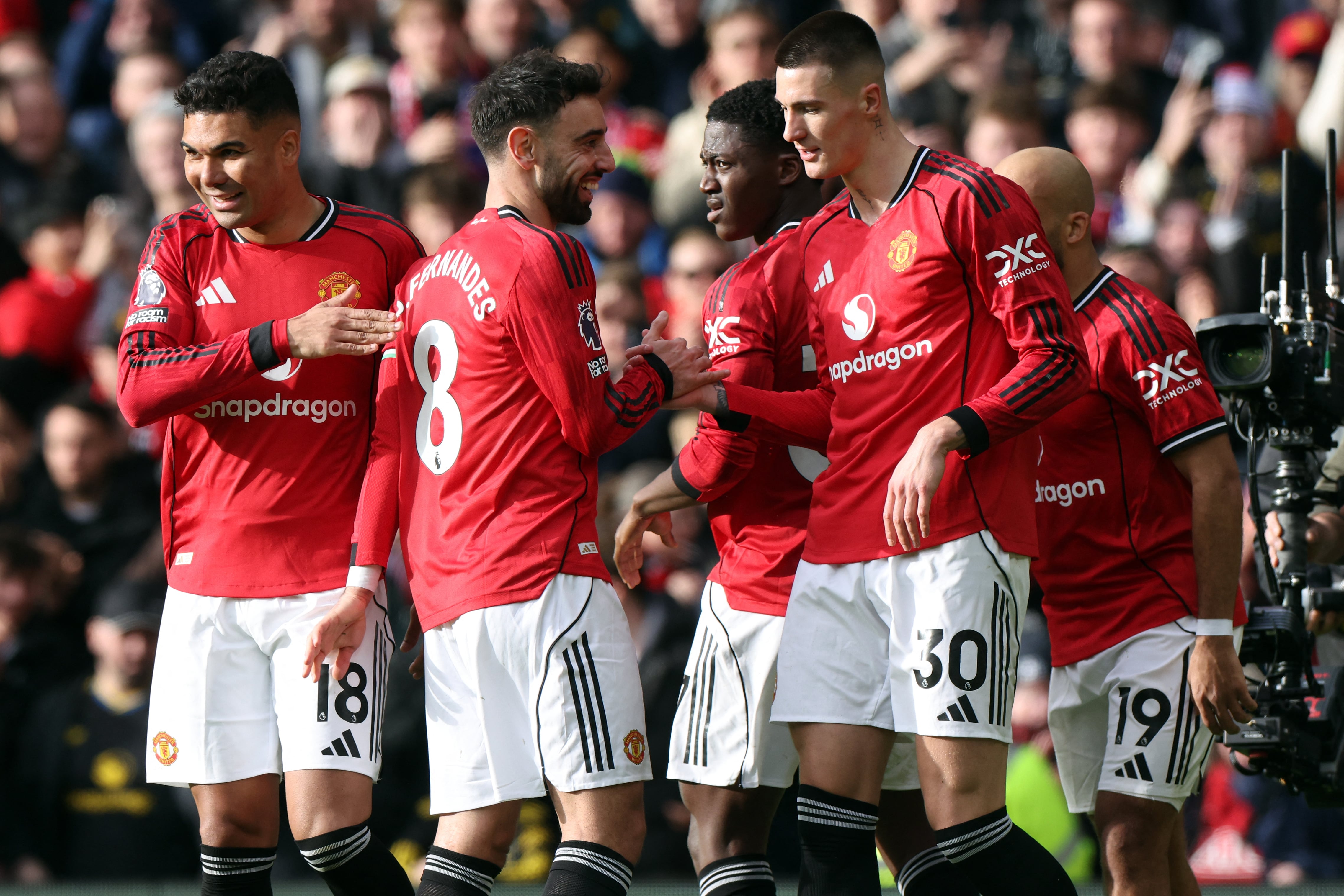 Manchester United's Slovenian striker #30 Benjamin Sesko (R) celebrates scoring his team's second goal during the English P at Old Trafford in Manchester, north west England, on March 1, 2026. (Photo by Darren Staples / AFP) /